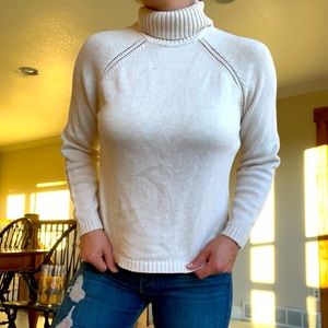 Cream-colored turtleneck sweater